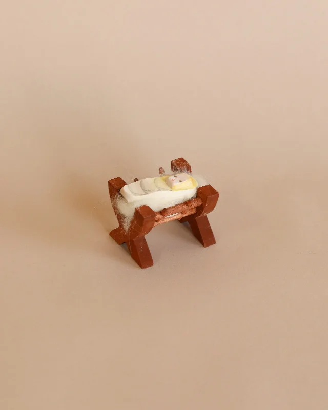 intricately carved wooden toys                   Ostheimer Baby In Crib